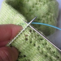 ... and start knitting **with your normal size needles**. The first few stitches may feel awkward because of the cut end still attached, but this is normal.